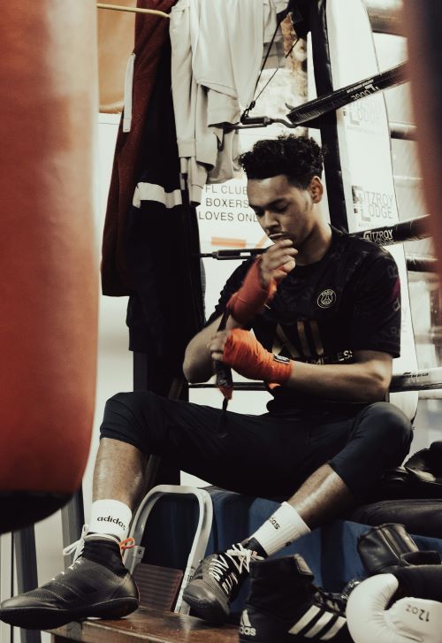 boxer wrapping hands at the side of the ring